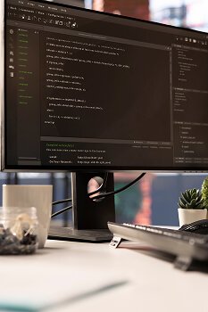 technician-looking-ui-computer-monitor-executing-programming-code